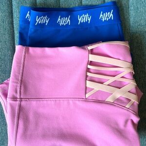 2 pair of bike shorts. One Yitty Blue Pair, other FABLETICS powerhold shorts.